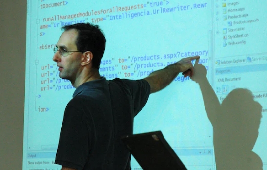 a trainer pointing to a board